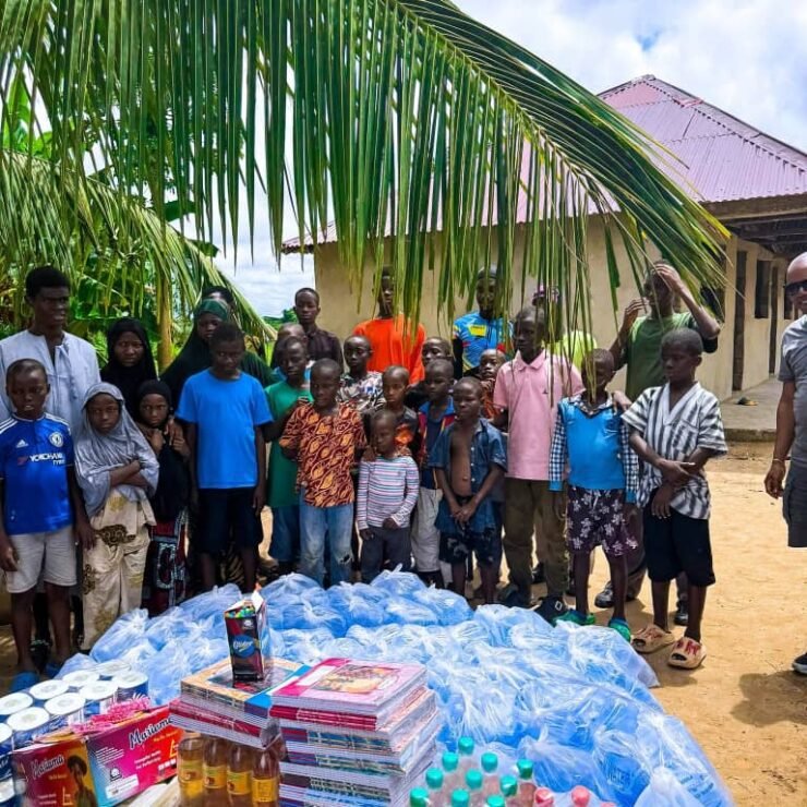 Emmiwuks engaging with children during a community charity outreach as part of his long-distance NIG2USA bicycle journey