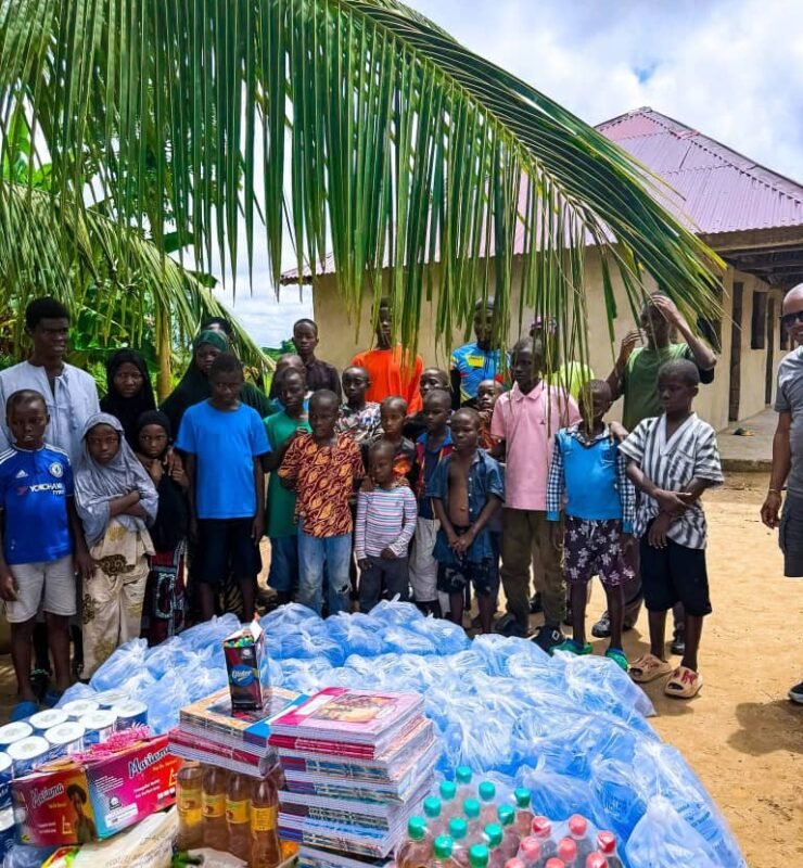 Emmiwuks engaging with children during a community charity outreach as part of his long-distance NIG2USA bicycle journey