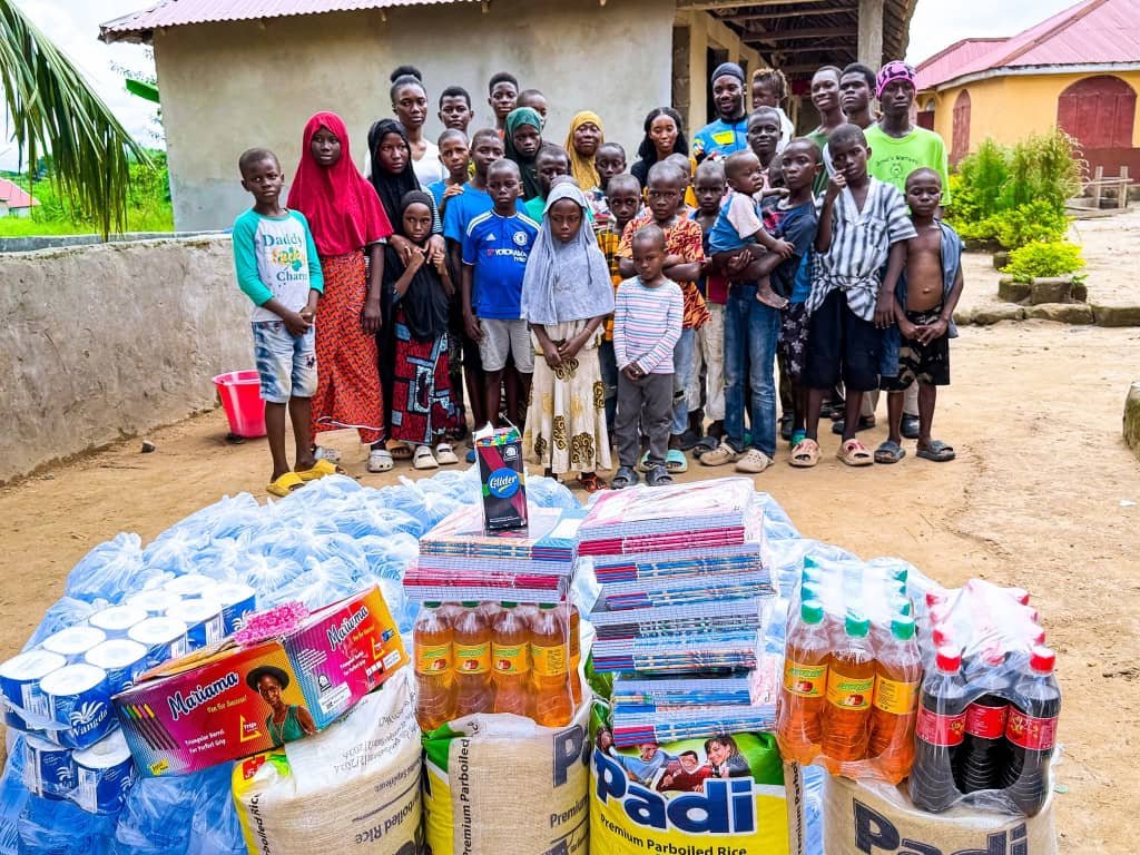 Emmiwuks interacting with orphaned children during his charity cycling mission aimed at supporting vulnerable African youth